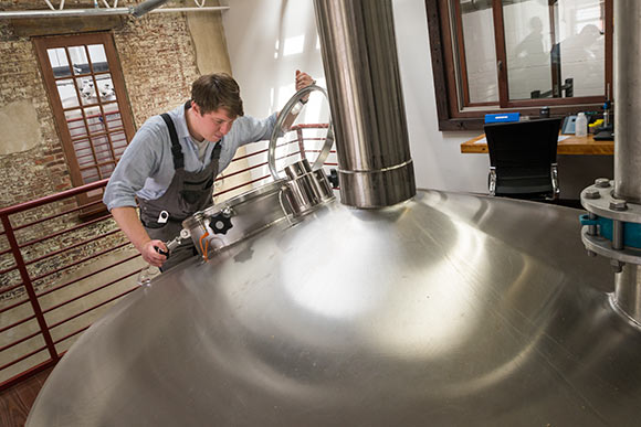 Brewer Patrick Daniels checking the fermentation tanks