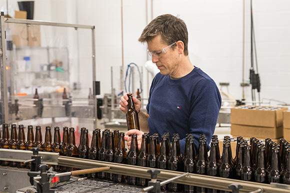 Co-founder Mark Priemer working on the bottling line on the first day of production