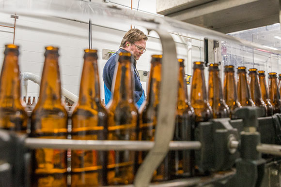 <span class="content-image-text">Brewmaster and co-founder Andy Tveekrem overseeing the bottling process</span>