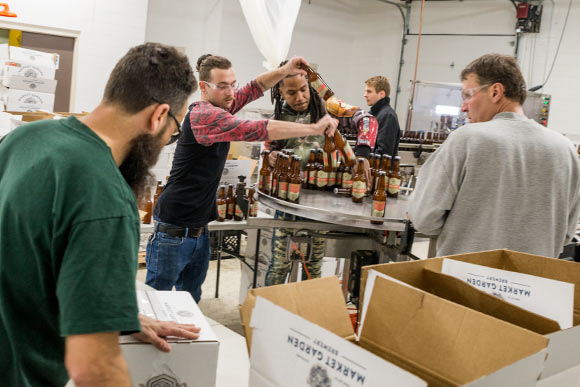 Packing and labeling on the first day of production at The Palace of Fermentation