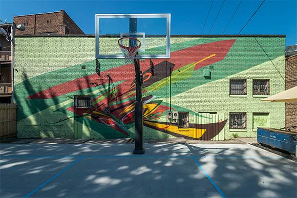 <span class="content-image-text">Basketball court and mural by local artist Bob Peck at the EDWINS Campus</span>