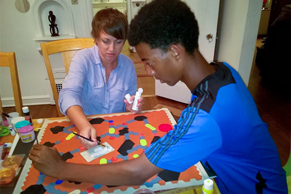 Aeronaut Noah Jalango and his mother working on the game board