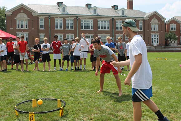 kids playing a game of spikeball