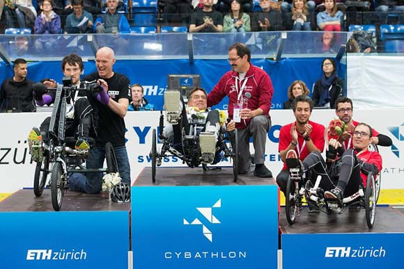 Cybathlon gold medal winner Mark Muhn (middle)