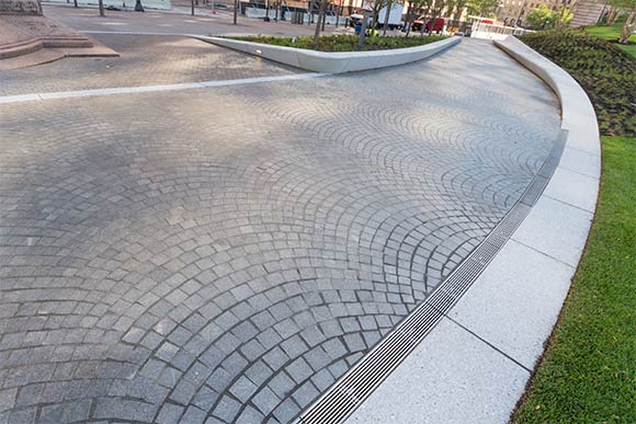 The promenade is made up of granite cobblestones in an infinite arcing pattern that winds throughout the square