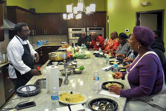 Chef Eric Wells teaching CMHA residents how to cook