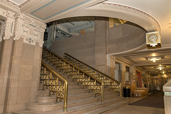 <span class="content-image-text">A grand marble staircase ascends from the lobby to a second floor community area</span>