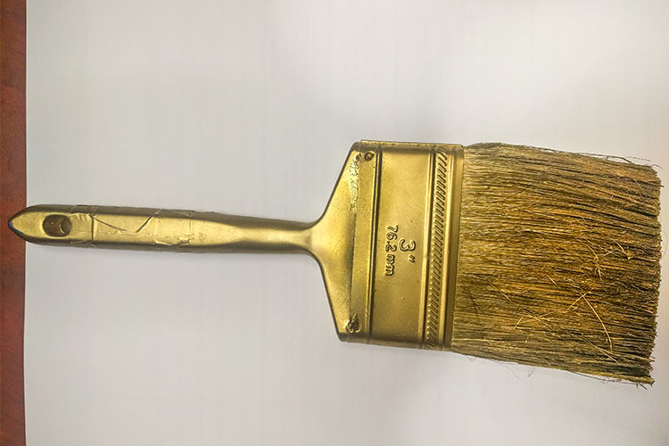 The golden paintbrush  retired from painting projects used to paint homes throughout the community by volunteers and then decommissioned and turned into works of art