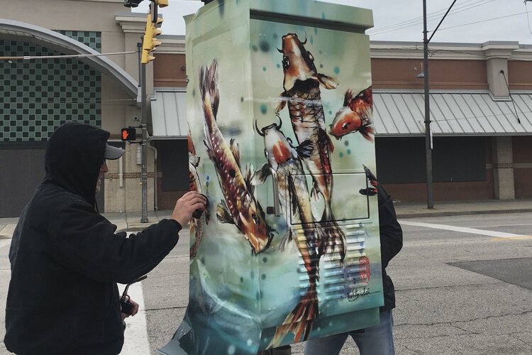 The utility box wrap titled “Happy Koi,” by Mitzi Lai, at East 33rd Street and Payne Avenue.