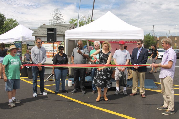 Kyle Dreyfuss-Wells, Chief Executive Officer NEORSD, cuts the dedication ribbon for the new parking lot