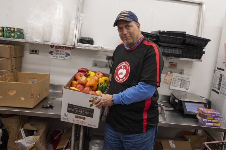 Food Rescue volunteer Tom Cardello picks up produce from a local grocer.