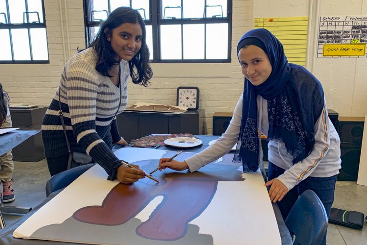 Students Mariam Kalil and Aayushi Shrivastava at Menlo Park Academy make signage this year for the Giant Eagle Market District store in Strongsville.