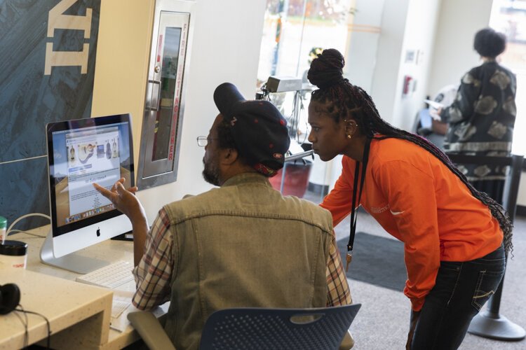 Helping out a Fairfax resident with computer use.