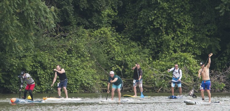 Stand up paddle boarders take off for a 6 mile race on Cuyahoga River at Rivergate Park in Cleveland outside Merwin's Wharf.