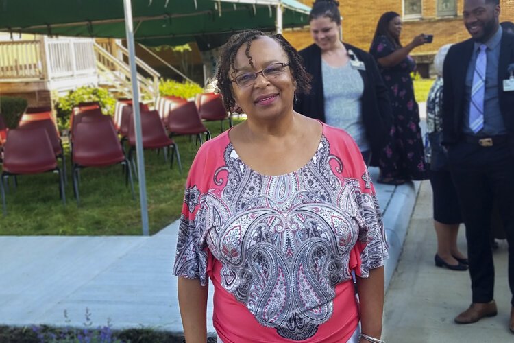 Denise VanLeer, executive director of the Fairfax Renaissance Development Center, attends the ribbon cutting.