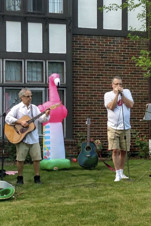 John Thayer plays with childhood friend Mitchell Cronig in an outdoor concert.