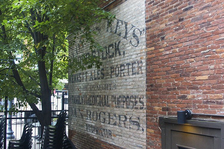 On the outer eastern wall of what used to be Market Tavern, a billboard still exists, touting the benefits of drinking their draught beer for “family and medicinal purposes.”