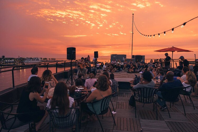 Pierce Edens bringing his special fusion of Appalachian folk and gritty rock to a Sofar crowd in awe of the sunset view of Lake Erie and the Rock Hall.