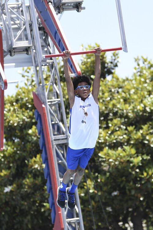 <span class="content-image-text">Nathanael Honvou competing in age group 9-10 on American Ninja Warrior Junior - Season 2.</span>