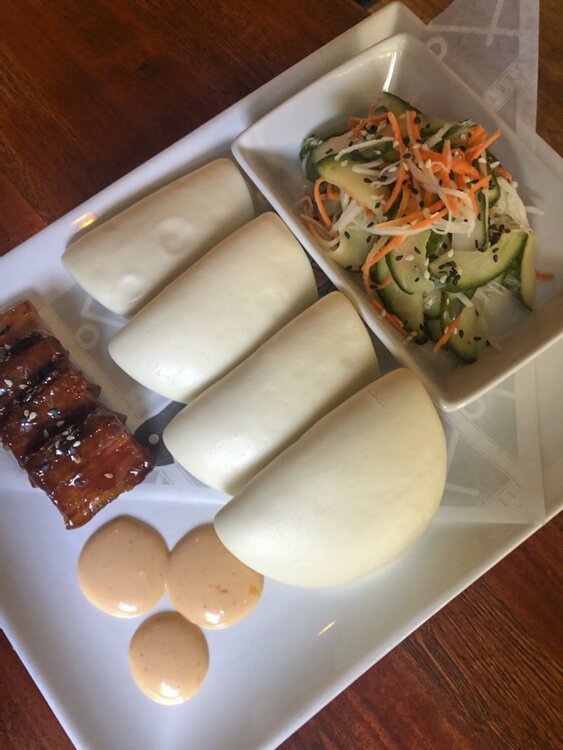 Fahrenheit appetizers, steamed buns with pork belly, cucumber salad and dipping sauces