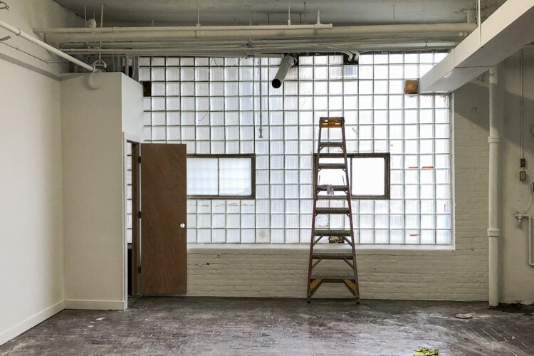 With the space cleared out, the original glass block that lines one wall lets in plenty of natural light.