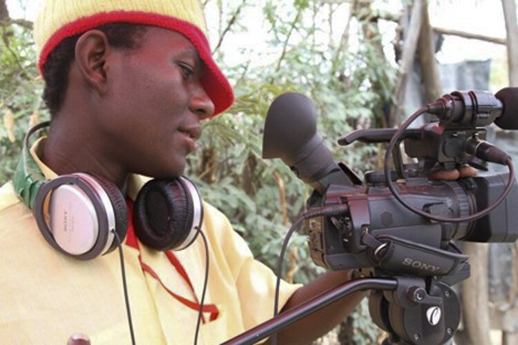 Mapembo circa 2012, filming a scene inside Kakuma Refugee Camp