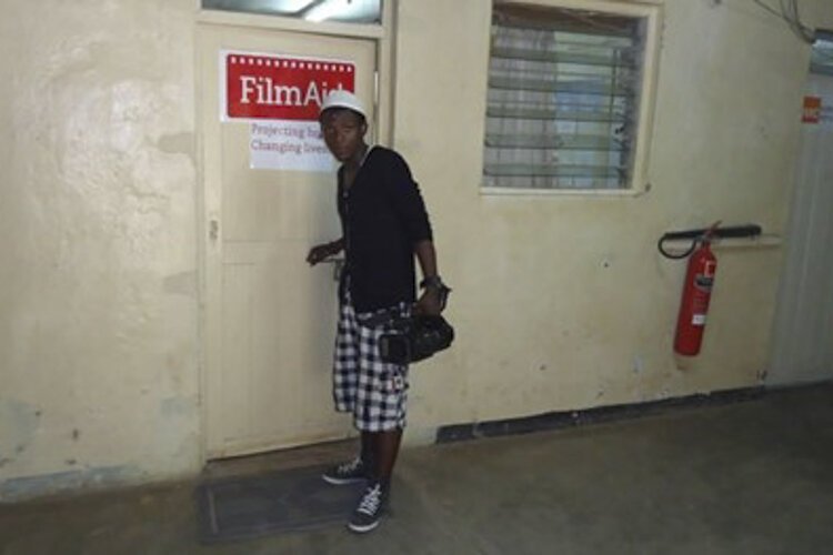 Mapembo outside the FilmAid office