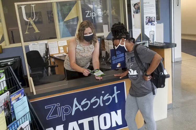 University of Akron Zip Assist staff help a student with Campus Cupboard program.