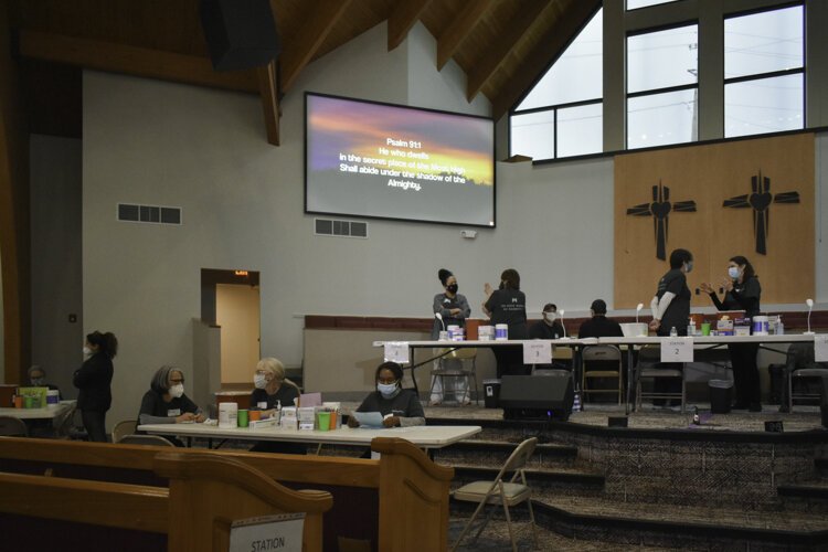 Workers with Cleveland nonprofit Medworks get things in order before a vaccine clinic begins at Affinity Missionary Baptist Church in Cleveland’s Lee-Miles neighborhood.