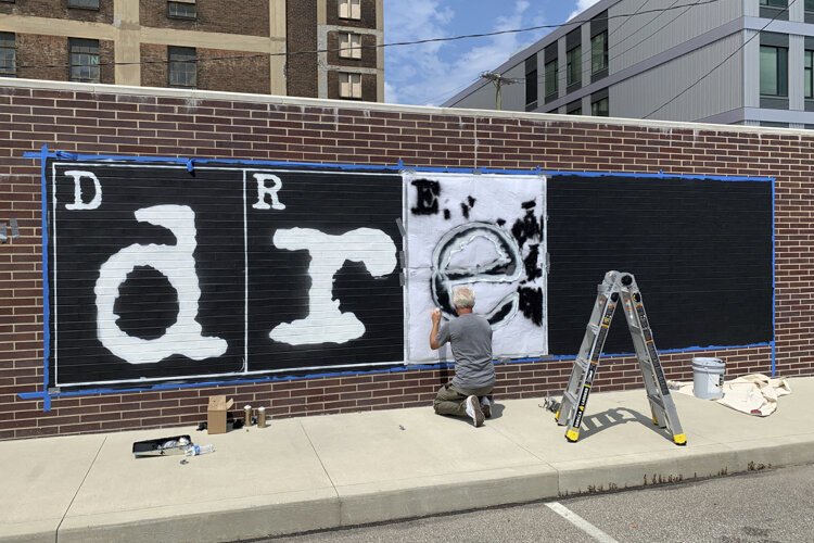 WRDSMTH “Dream Bigger” mural painted on 8/9 at 2160 Payne Avenue.