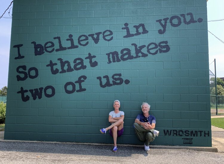 Graffiti HeArt president and founder Stamy Paul and street artist WRDSMTH pose under the “2 Believe” mural in Madison Park at 13201 Madison Avenue.