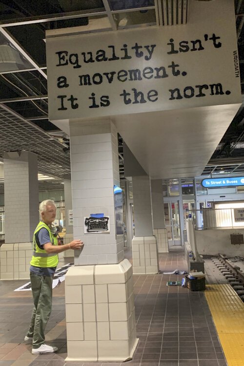 Street artist WRDSMTH working on his mural “Equality” mural at Tower City in Public Square.