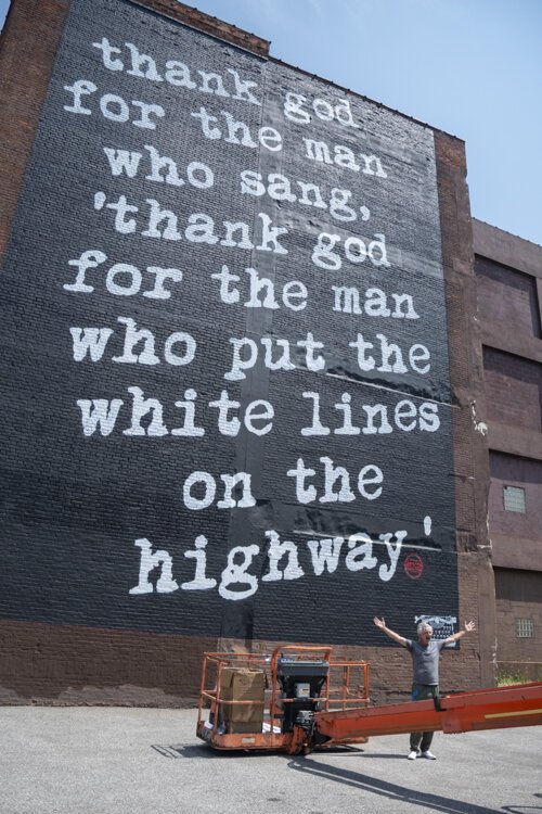 <span class="content-image-text">Cleveland native and Los Angeles-based street artist WRDSMTH just after finishing his “Lover” Micheal Stanley tribute mural on Payne Ave.</span>