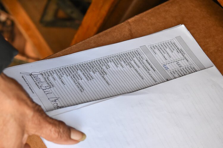 <span class="content-image-text">Janet Gill-Cooks runs down the list of bills she’s required to provide in order to qualify for assistance.</span>