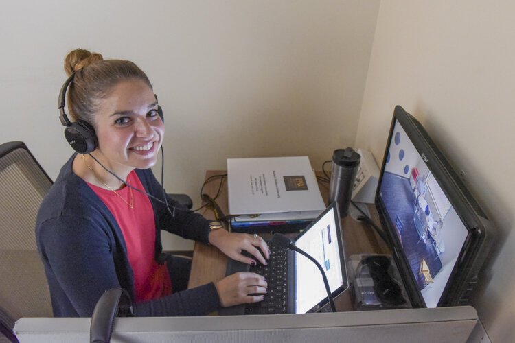 Student working with children and adult clients in The Baldwin Wallace Speech Clinic and family feeding center.