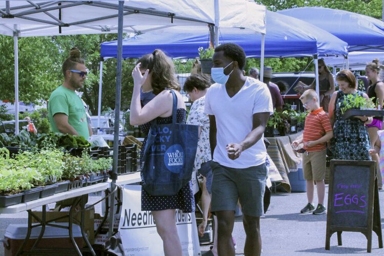 <span class="content-image-text">Andrew Needham, the director of Needham Gardens, sells produce at Kamm’s Corners Farmers Market in Cleveland’s West Park neighborhood.</span>