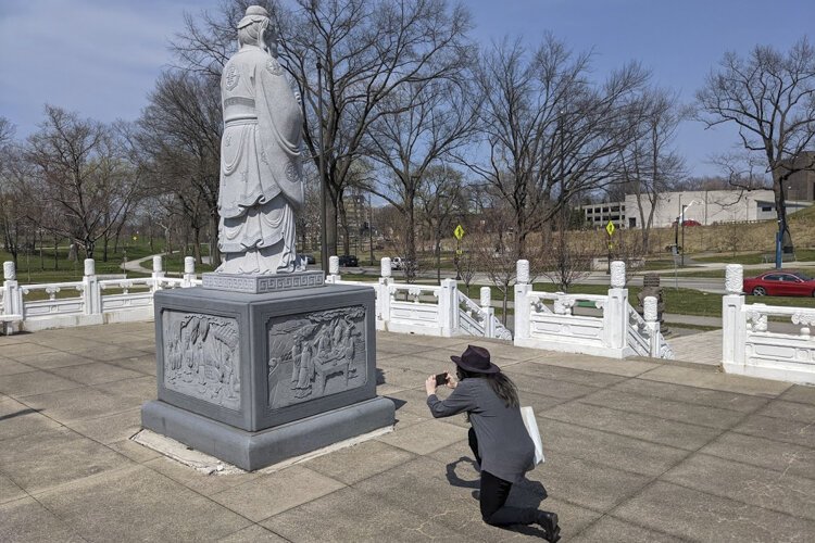 Aubrey O'Brien photographs a sculpture at the Chinese Cultural Garden for the Ohio Outdoor Sculpture inventory.