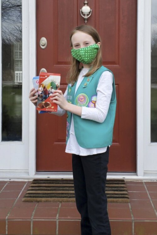 <span class="content-image-text">Abigail Gold, of Troop 71672, makes a socially-distanced cookie delivery.</span>