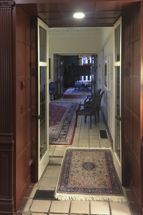 Italian tile through a hall that leads to the living and dining rooms inside the Drury house.