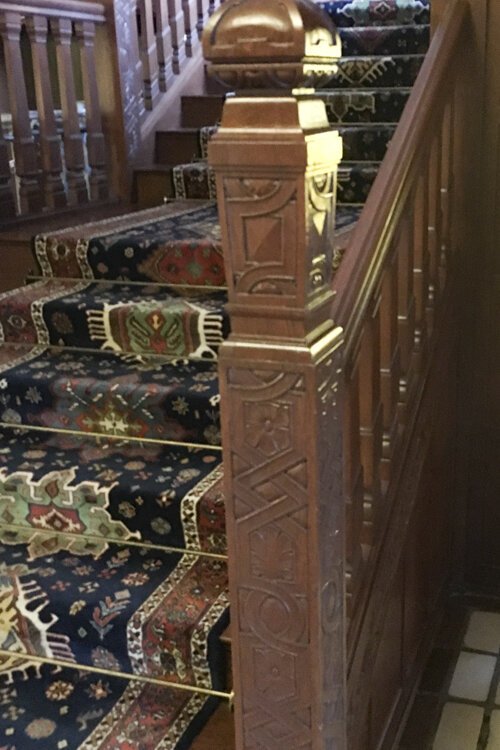 The Drury house entryway staircase with ornate oak.