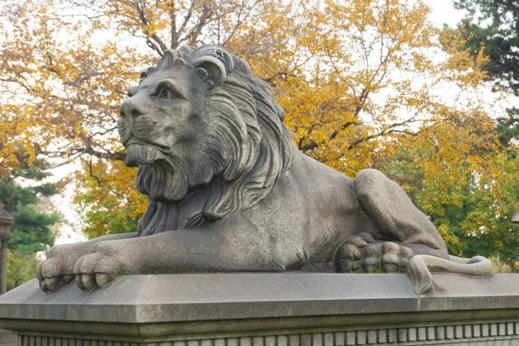 A stone lion sits atop the grave marker of Clevelander John Daykin, a stonemason-turned railway man.