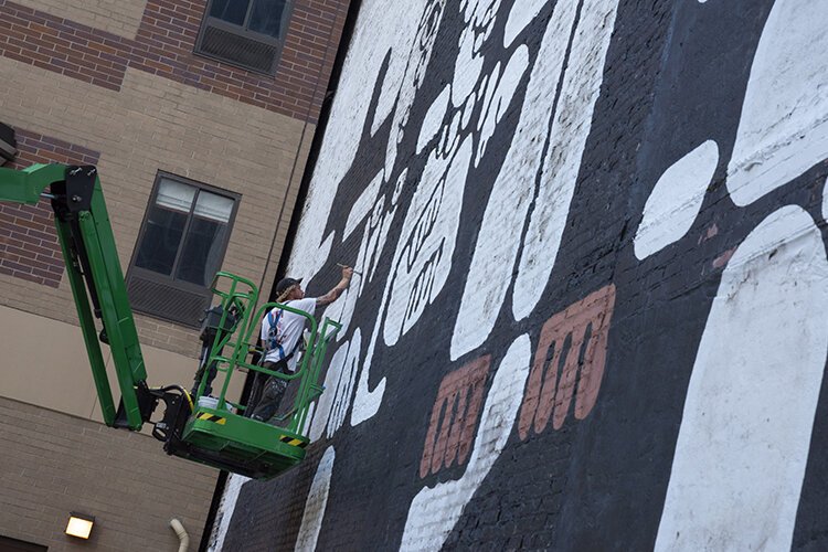 Alan Giberson of the Old Soul Sign Co., working on the restoration of the mural.