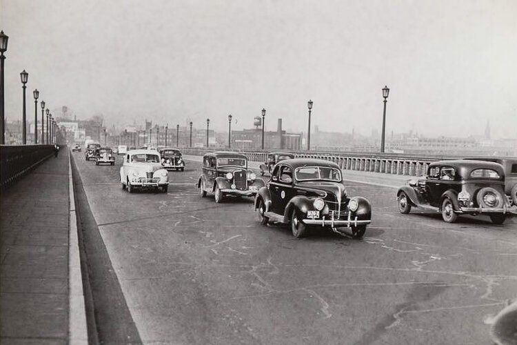 Cars drive on the Lorain-Carnegie Bridge in 1941.