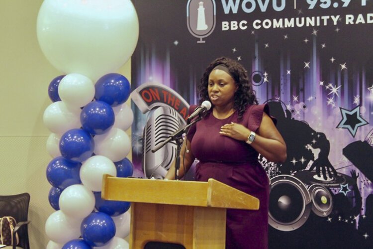 Joy Johnson, the executive director of Burten, Bell, Carr, a development corporation in Kinsman, speaks at the ribbon-cutting ceremony of Colfax Family Homes, on August 25, 2021.