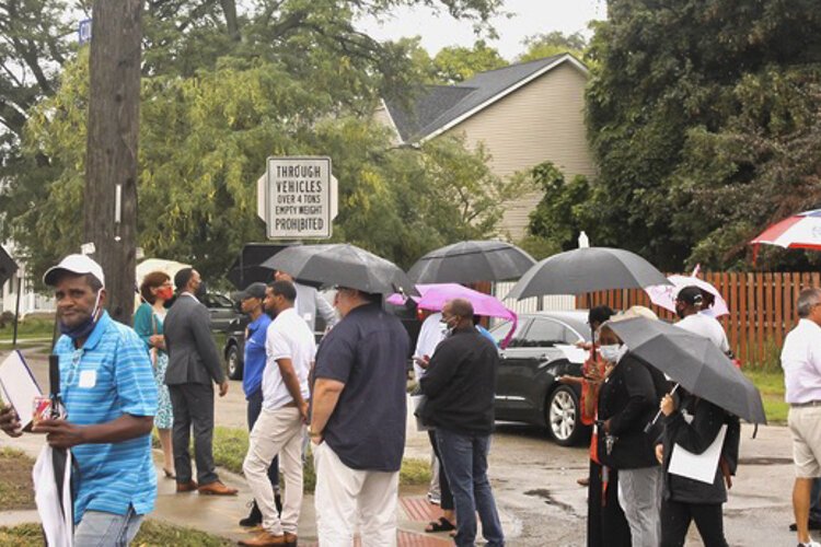 <span class="content-image-text">New residents, stakeholders and neighors gather in front of 2938 Minnie Rd. for a walking tour of one of the Colfax properties, on August 25, 2021.</span>