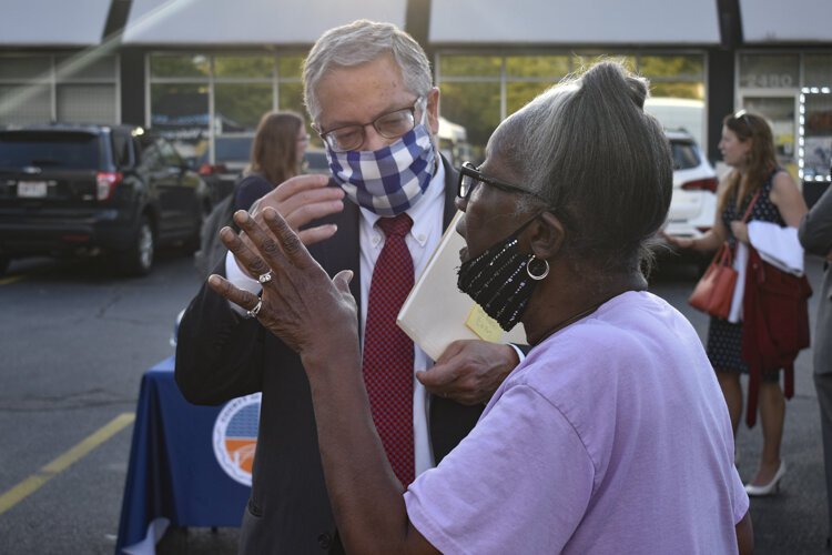 County Executive Armond Budish speaks to a resident during the event in the Central neighborhood.