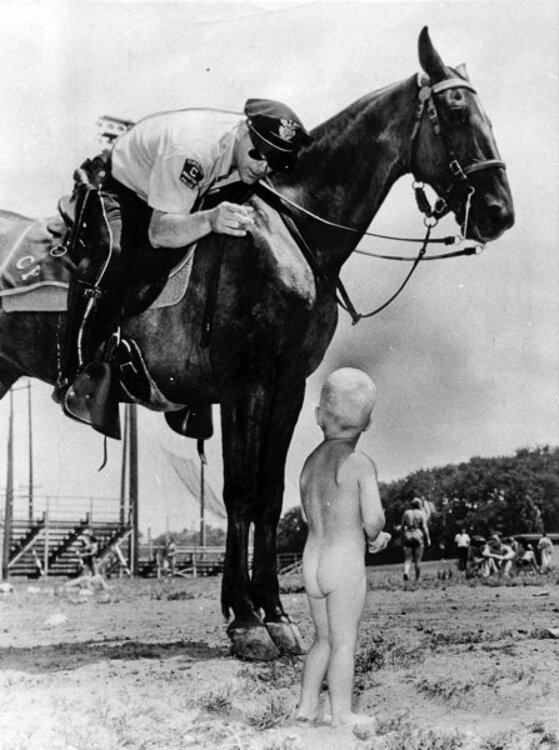 Two year old David Brzowski gets  a warning to put his trunks on by Police Mountie Jim Kennedy in this Cleveland Press photo from 1965.