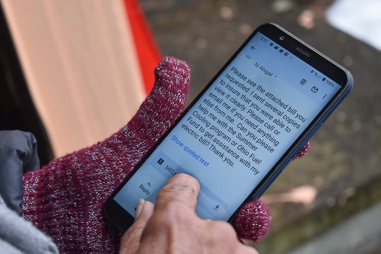 <span class="content-image-text">Garfield Heights resident Janet Gill-Cooks looks through her phone at communications she’s had with local agencies, trying to get relief for her water bills.</span>