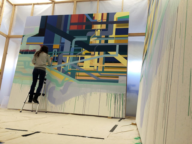 Dana Oldfather works on one of two "Reflexive" panels