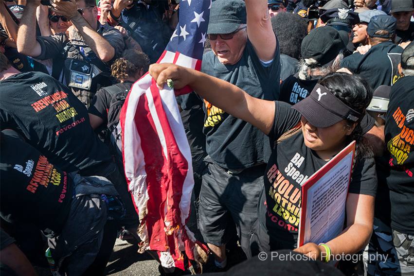 Protesters light a flag on fire, causing chaos on E. 4th